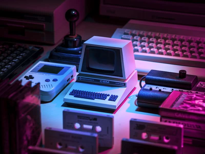 The blog's founder at a desk surrounded by monitors and controllers